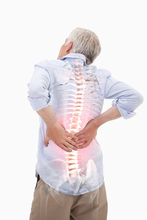 Digital composite of Highlighted spine of man with back pain