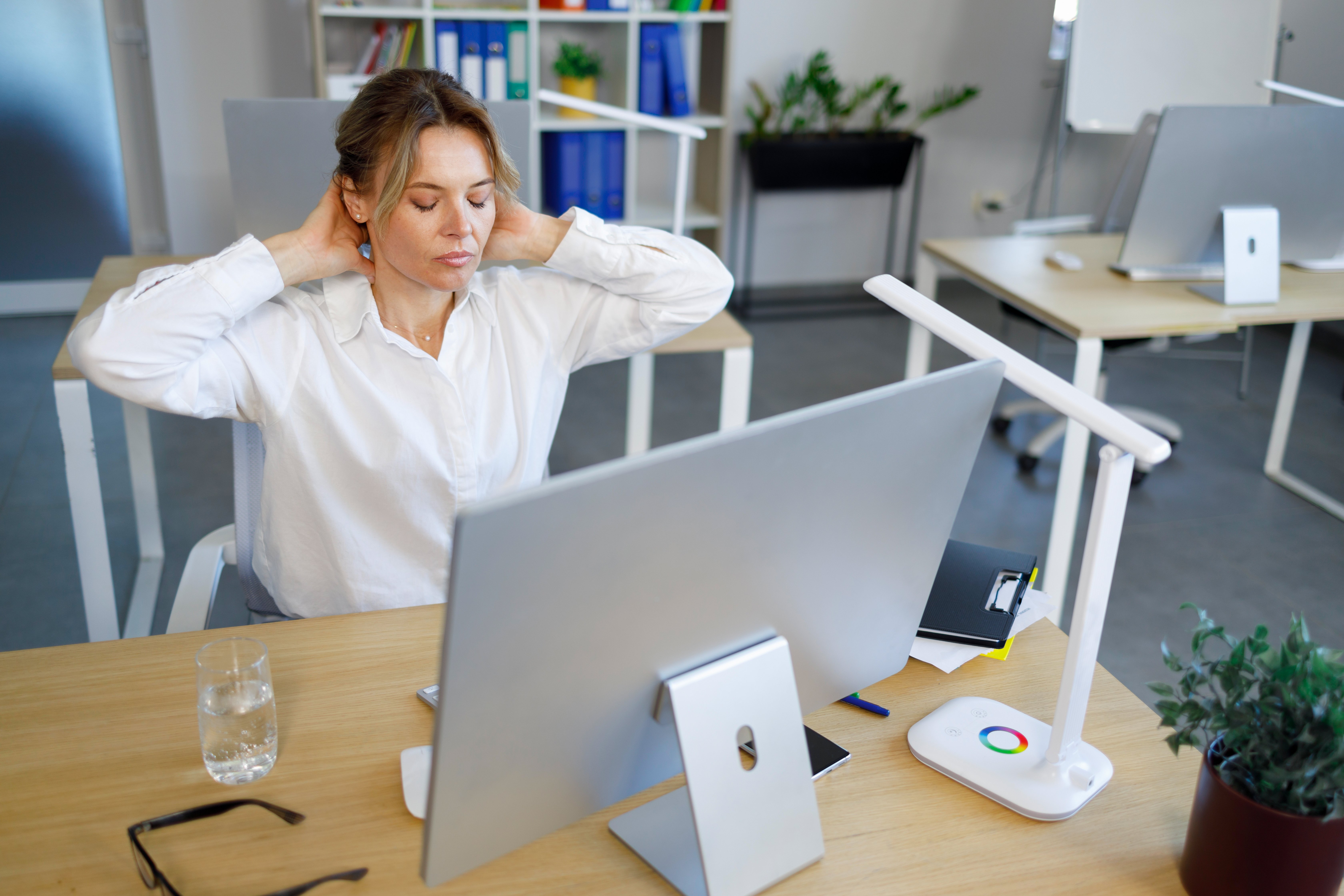 female-office-worker-stretching-for-relaxing-while-2023-11-27-05-02-25-utc